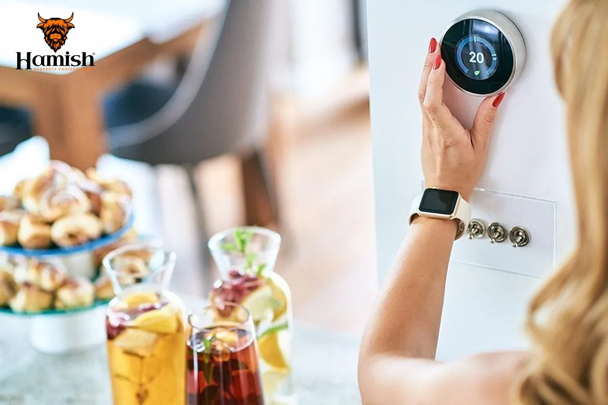 Hand adjusting a smart thermostat to control home heating and energy use
